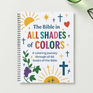 May include: A spiral-bound colouring book titled "The Bible in All Shades of Colors." The cover features colourful text, crosses, a heart, sunbursts, and illustrations of grapes and leaves. The book is designed for colouring through all 66 books of the Bible.