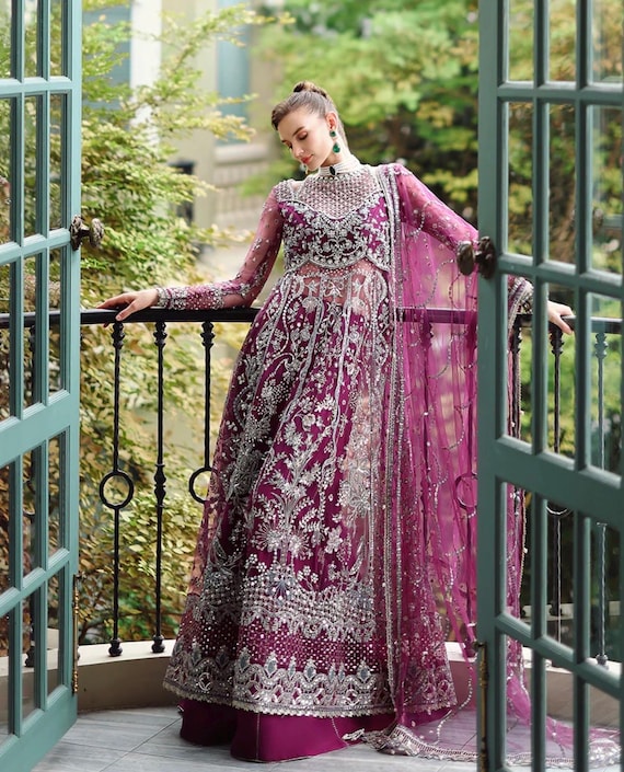 nikkah dress pink Pink Side Slit Open Maxi for Nikkah This elegant front open slit gown paired with a flowing lehenga is crafted in different hues of pink, blending the delicate beauty of organza with