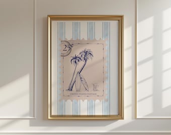 May include: Framed artwork featuring a vintage postage stamp design. The stamp depicts two palm trees, surfboards, and the text "UNITED STATES POSTAGE". The stamp is set against a light blue and white striped background, framed in gold.