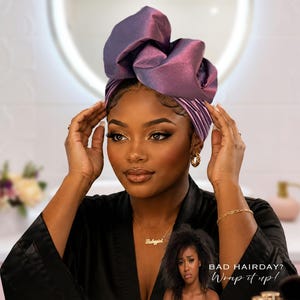 May include: A woman wearing a purple and pink satin head wrap. The head wrap is styled in a large, decorative knot. The image includes the text "BAD HAIRDAY? Wrap it up!"