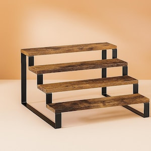 May include: A four-tiered display stand with a rustic design. The shelves are made of wood with a brown finish, supported by a black metal frame. The stand is ideal for displaying small items, with each shelf measuring approximately 12 inches in length.
