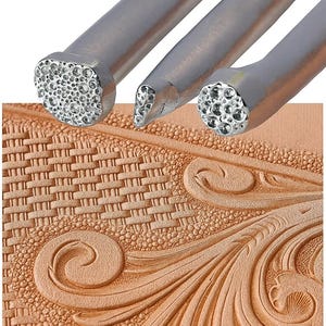 May include: Close-up of three metal leatherworking tools with textured ends, alongside a piece of embossed leather. The tools have different shaped heads for creating various patterns. The leather has a basketweave and floral design.
