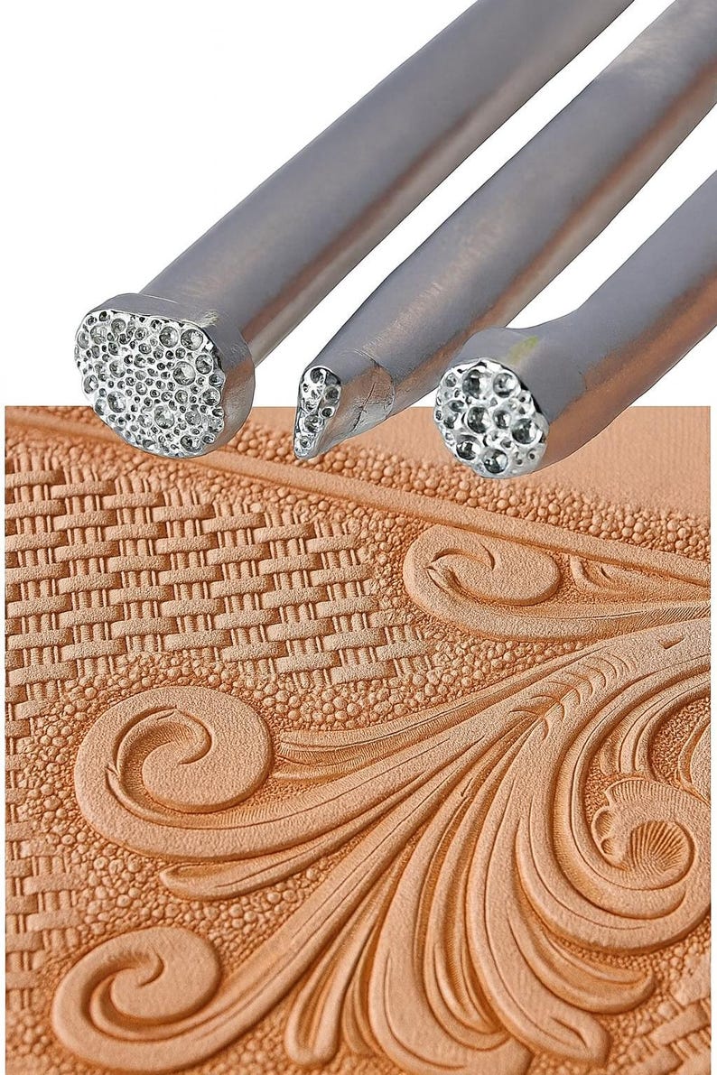 May include: Close-up of three metal leatherworking tools with textured ends, alongside a piece of embossed leather. The tools have different shaped heads for creating various patterns. The leather has a basketweave and floral design.