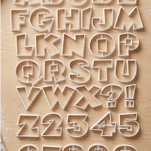 May include: A set of three ceramic mugs with a speckled, matte finish. The mugs are in shades of cream, light gray, and dark gray. Each mug has a simple, minimalist design, perfect for coffee or tea.