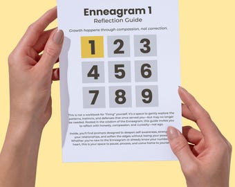May include: A white Enneagram 1 Reflection Guide held by hands. The guide features a grid of numbers 1-9, with the number 1 highlighted in yellow. Text on the guide includes "Growth happens through compassion, not correction."