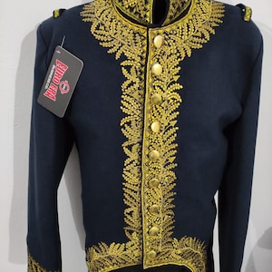 May include: A navy blue jacket with gold embroidery. The jacket has a high collar, gold buttons, and gold trim on the cuffs and shoulders. A tag from "Euro Era Business Co." is attached.