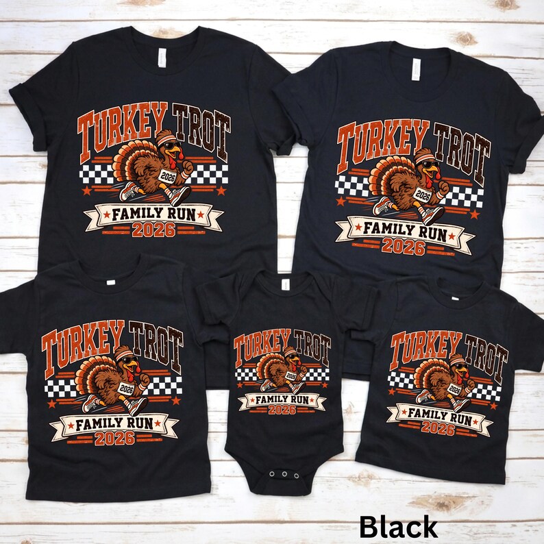 May include: A collection of five black t-shirts and one black baby bodysuit featuring a graphic of a running turkey wearing a headband and sneakers. The text reads Turkey Trot Family Run 2026 with a checkered flag pattern and orange accents.