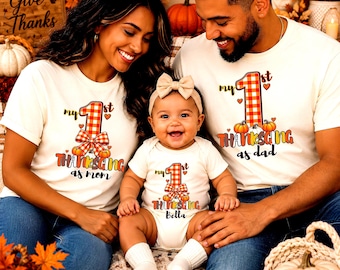 May include: Matching white t-shirts and a baby bodysuit featuring a red and white plaid number one, pumpkins, and bows. The shirts read My 1st Thanksgiving as mom and My 1st Thanksgiving as dad, while the bodysuit reads My 1st Thanksgiving Bella.
