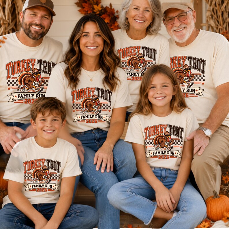 May include: A group of people wearing matching cream-colored t-shirts featuring a graphic of a turkey wearing a hat and running shoes. The text reads Turkey Trot Family Run 2026, accompanied by a checkered pattern and red and orange accents.