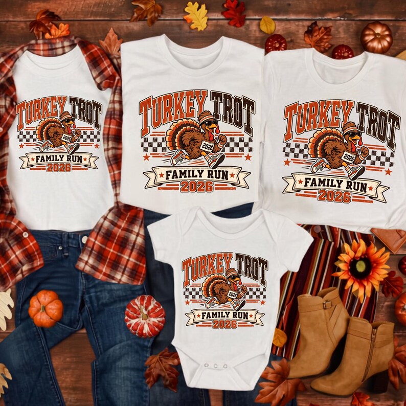 May include: Three white t-shirts and one white baby bodysuit featuring a graphic of a running turkey wearing a hat and sneakers. The text reads Turkey Trot Family Run 2026. The design includes a checkered pattern and orange and brown accents.