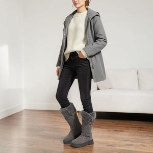 May include: A set of three ceramic mugs with a speckled, matte finish. The mugs are in shades of cream, light gray, and dark gray. Each mug has a simple, minimalist design, perfect for coffee or tea.