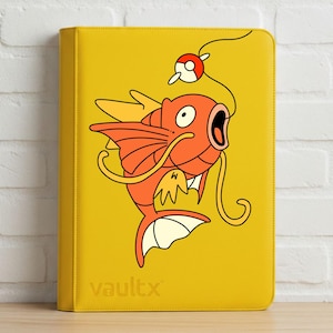 May include: A bright yellow binder featuring a graphic illustration of an orange fish with a wide open mouth, long whiskers, and fins. A red and white spherical object hangs from a line above the fish. The word vaultx is printed in the bottom corner.