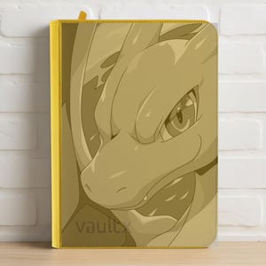 May include: A yellow card binder featuring a detailed illustration of a dragon's face. The binder has a yellow spine and the word "Vaultx" is printed on the front.