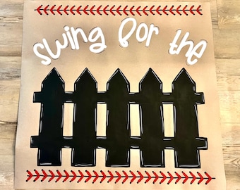 May include: A baseball-themed sign with the words "Swing for the" in white, above a black picket fence illustration. Red stitching accents the top and bottom edges, resembling baseball seams. The background is a light brown.
