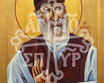 May include: A religious icon painting of Saint Paisios of Mount Athos featuring a gold leaf background, a dark brown skullcap, a white beard, and a maroon vest over a light blue robe. The figure holds a wooden staff and raises one hand in blessing.