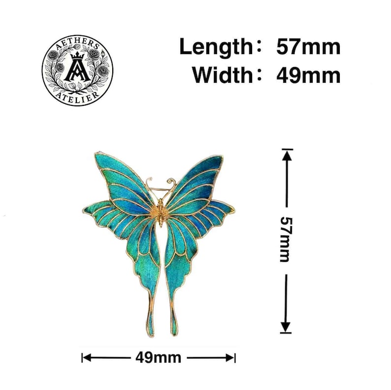 May include: A detailed butterfly brooch in shades of blue and gold. The brooch measures 5.7cm in length and 4.9cm in width. The image includes the text "Length: 57mm, Width: 49mm" and the Aethers Atelier logo.