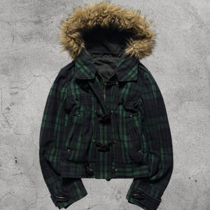 May include: A green and navy plaid jacket with a faux fur-lined hood. The jacket has a zip-up front, toggle fastenings, and pockets. The jacket is a cropped style.