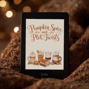 May include: A black e-reader displaying a screen with the text Pumpkin Spice and Plot Twists in brown cursive font. Below the text are illustrations of four mugs filled with beverages, a stack of three books, and small orange pumpkins.