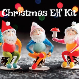 May include: The image features three whimsical Christmas elf figurines. Each elf has a round body, a white beard, and a colorful outfit. The text "Christmas Elf Kit" is displayed at the top. The elves are posed on pinecone bases.
