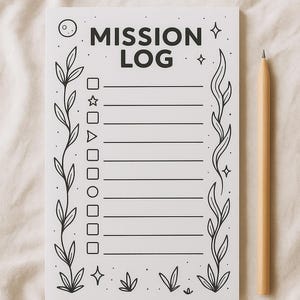 May include: A white notepad with the words "MISSION LOG" in bold black letters. The notepad has a decorative floral border and a wooden pencil. The notepad has a series of lines and check boxes for writing.