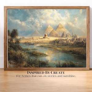 May include: A framed landscape painting depicting the Great Pyramids and the Sphinx in Egypt, with a river in the foreground, palm trees, and ancient structures. The text below reads: INSPIRED BY CREATE For homes that run on stories and sunshine.