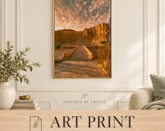 May include: A rectangular wall art print featuring a landscape of an ancient stone temple structure with a long walkway leading toward a cliffside, set against a dramatic golden sunset sky with textured clouds and rocky terrain.