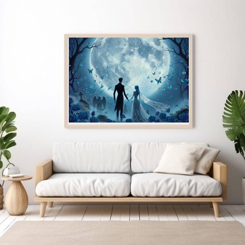 May include: A framed art print depicts a couple holding hands, silhouetted against a large, glowing blue moon. The scene includes blue roses, butterflies, and trees, creating a romantic, fantasy-themed image. The artwork is displayed above a white sofa.