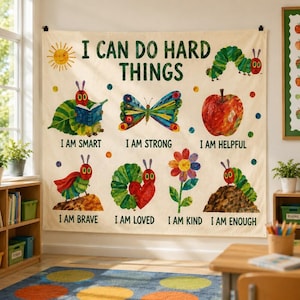 May include: A cream-colored wall tapestry featuring the text I CAN DO HARD THINGS and illustrations of a caterpillar, butterfly, apple, and flower. The design includes phrases like I AM SMART, I AM STRONG, I AM HELPFUL, I AM BRAVE, I AM LOVED, I AM KIND, and I AM ENOUGH.