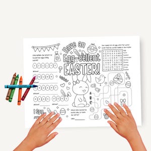 May include: An Easter-themed activity sheet with the words "Have an Egg-cellent Easter!" and various puzzles, including unscrambling words and a maze. Crayons in green, brown, orange, and red are placed on the left side of the sheet.