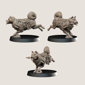 May include: Three grey miniature dog figurines in dynamic poses. Each dog is wearing armour and has a curled tail. One dog holds a spear in its mouth. The figurines are mounted on black circular bases.