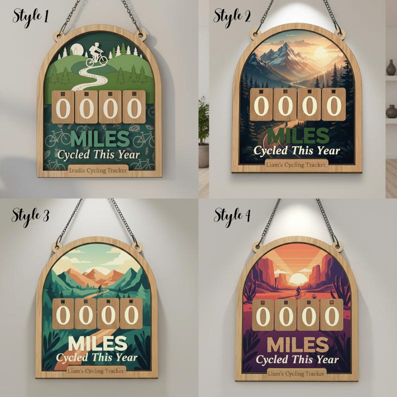 May include: Wooden cycling tracker with a decorative arched frame. The tracker displays "0000 MILES Cycled This Year". The background features a landscape scene with a cyclist. The tracker is suspended by a chain.