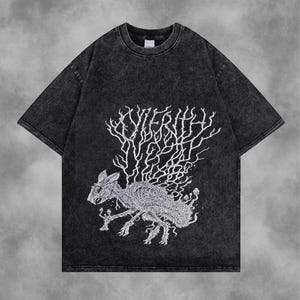 May include: Dark grey t-shirt with a distressed finish. The front features a white graphic of a skeletal rabbit with a tree-like design and the word "Xyierith". The shirt has short sleeves and a crew neck.