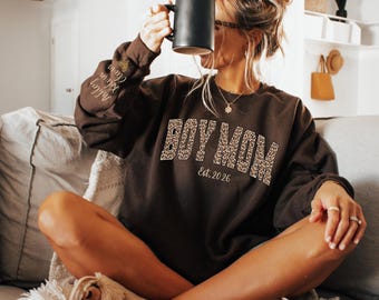 Custom Leopard Boy Mom Sweatshirt With Kid Name On Sleeve, Personalized Boy Mom Sweatshirt, Gift For Mom, Mothers Day Gift, Mom Est Year