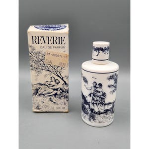 May include: A white perfume bottle and box set. The bottle and box feature a blue and white pastoral design. The box reads "REVERIE EAU DE PARFUM" and the bottle is 3 fl oz.