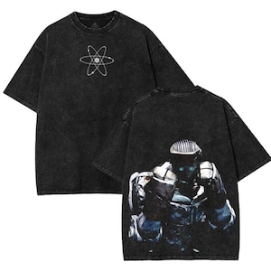 May include: Black, oversized t-shirt with a faded, vintage appearance. The front displays a white atom symbol, and the back features a detailed robot graphic. The shirt has short sleeves and a crew neck.