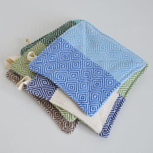 May include: Set of four woven pot holders in blue, green, brown, and white with a diamond pattern.