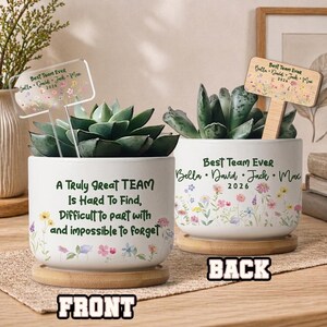 May include: Two white ceramic succulent pots with wooden bases. One pot has the text "A Truly Great TEAM Is Hard To Find, Difficult to part with and impossible to forget." The other pot says "Best Team Ever" with names and the year 2026.