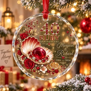 May include: A round, clear glass ornament featuring a red ribbon hanger. The design includes a seashell holding a large red gemstone, red roses, and two gold rings. Text reads 40th Ruby Anniversary, Margaret & Richard, and 1986-2026.