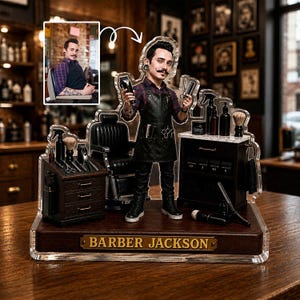 May include: A custom acrylic figurine of a barber with a moustache, wearing a plaid shirt and black apron, holding clippers and scissors. The display includes a miniature barber chair, workstation, and tools, with a nameplate reading BARBER JACKSON.