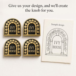 May include: Four arched cabinet knobs with a gold-toned finish and black background, featuring an ivy leaf motif and the text "IVY HOUSE". Next to them is a paper card with a black ink sketch labelled "Sample design" of the same arch.