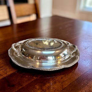 May include: A handcrafted wooden serving tray with a natural finish. The rectangular tray has raised edges and integrated handles. The wood grain is visible, highlighting its rustic charm. Dimensions are approx. 40 cm long, 25 cm wide, and 5 cm deep.