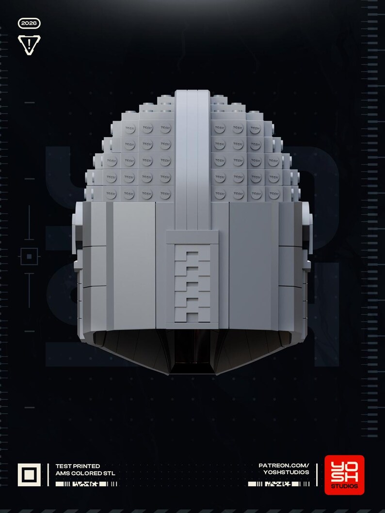 May include: A gray, geometric helmet constructed from small, square blocks. The helmet has a rounded top and a rectangular faceplate with a series of horizontal lines. The image includes the text "2020", "TEST PRINTED AMS COLORED STL", and "YOSH STUDIOS".