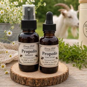 May include: Two amber glass bottles with black caps, one featuring a spray nozzle and the other a dropper. The labels read Honey Hill Homestead Propolis Spray and Propolis Tincture, with the text Bee Well, Live Well and MalloryMarket.com.
