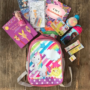 Unicorn backpack filled with activities and games to use during travels, restaurant visits and more .... Kidz BUZY Bagz