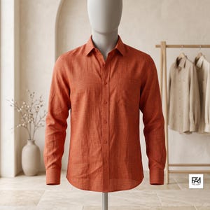 May include: A long-sleeved button-down shirt in a solid burnt orange color with a visible woven texture. The shirt features a classic collar, a single chest pocket on the left side, and matching orange buttons running down the center front placket.