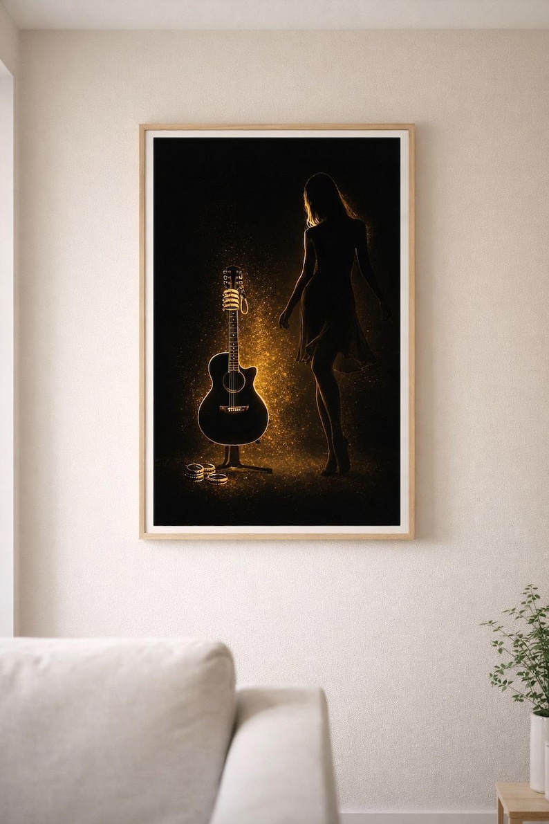 May include: A framed art print featuring a black acoustic guitar with golden highlights, a silhouette of a person, and golden sparkles against a dark background. The artwork is displayed in a room with a neutral color palette.