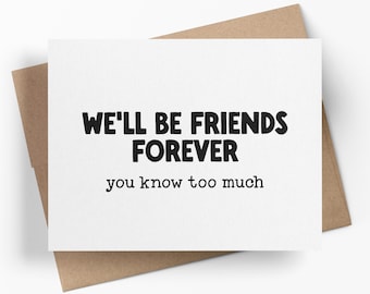 May include: A white rectangular greeting card with black text that reads WE'LL BE FRIENDS FOREVER you know too much, positioned on top of a brown kraft paper envelope. The card features a bold, sans-serif font for the first line and a smaller, typewriter-style font for the second line.