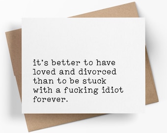 May include: A white greeting card with black typewriter-style text that reads: it's better to have loved and divorced than to be stuck with a fucking idiot forever. The card is placed on top of a brown kraft paper envelope.