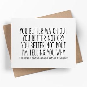 May include: A white greeting card with black text that reads: YOU BETTER WATCH OUT, YOU BETTER NOT CRY, YOU BETTER NOT POUT, I'M TELLING YOU WHY, (because santa hates little bitches). The card is placed on top of a brown paper envelope.
