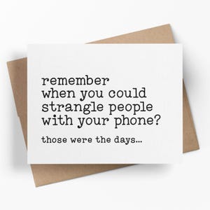 May include: A white greeting card with black text that reads "remember when you could strangle people with your phone? those were the days..." The card is on a brown envelope.